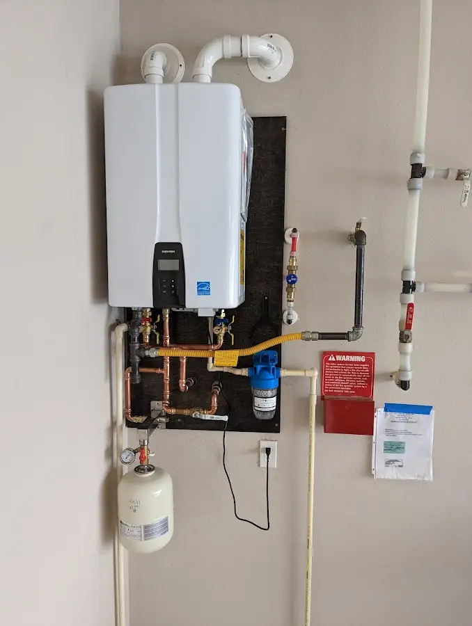 Professional plumber installing copper piping in a Shady Hollow home